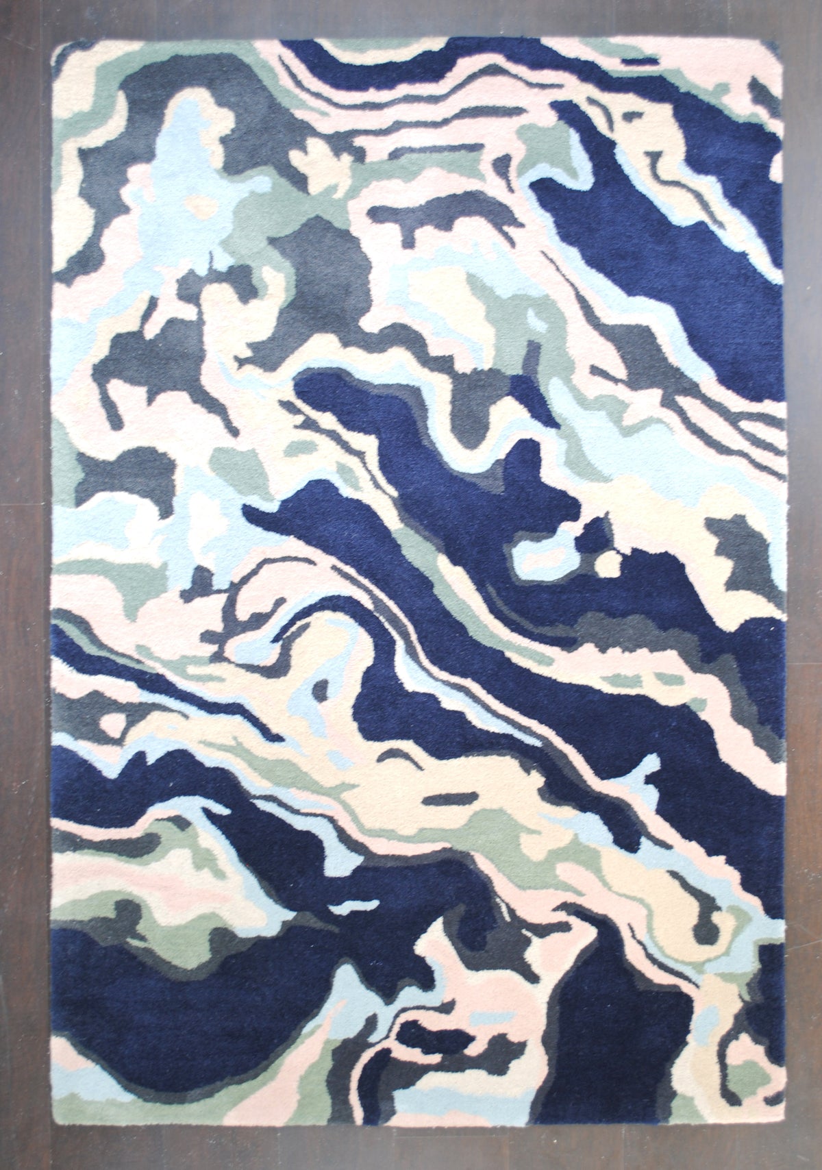 Makrana hand-tufted wool rug with marbled navy, blush and sky blue bands