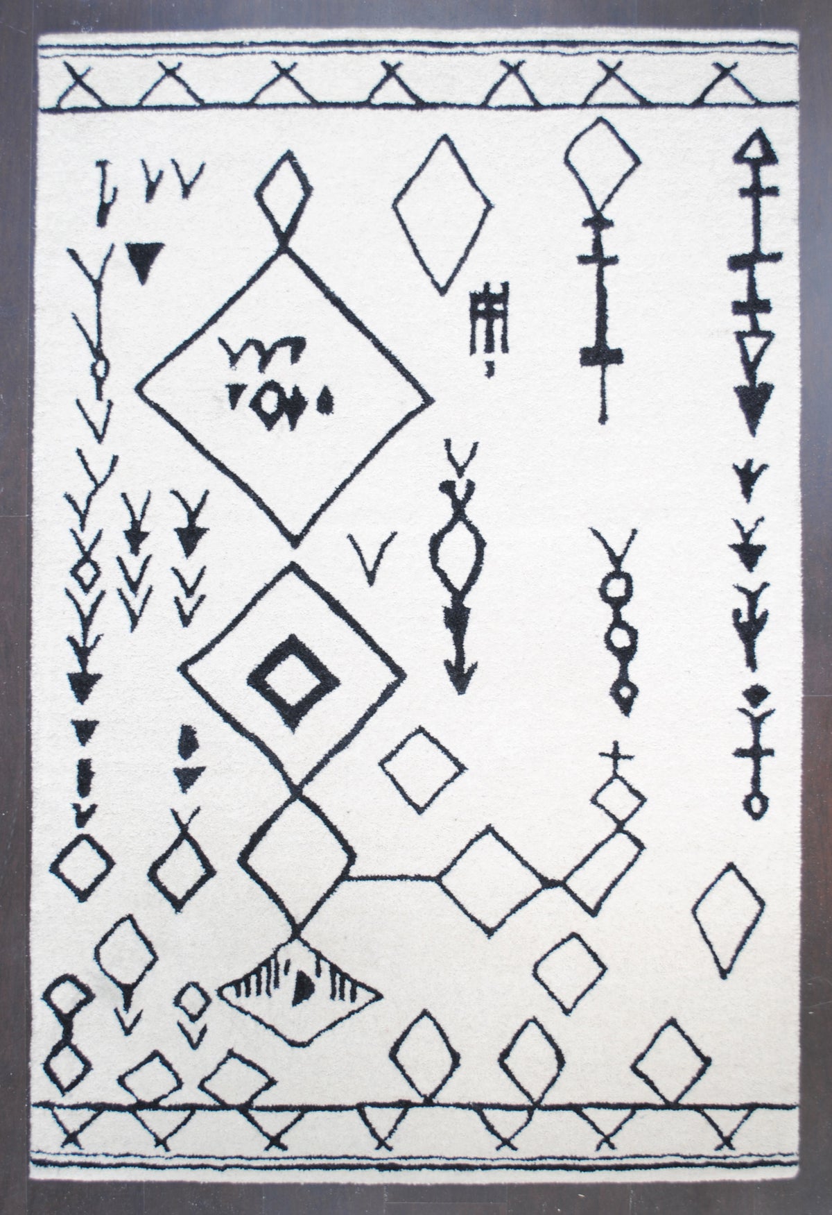 Spiti Hand-Tufted Rug laid flat on a dark wood floor, full view — Art Avenue