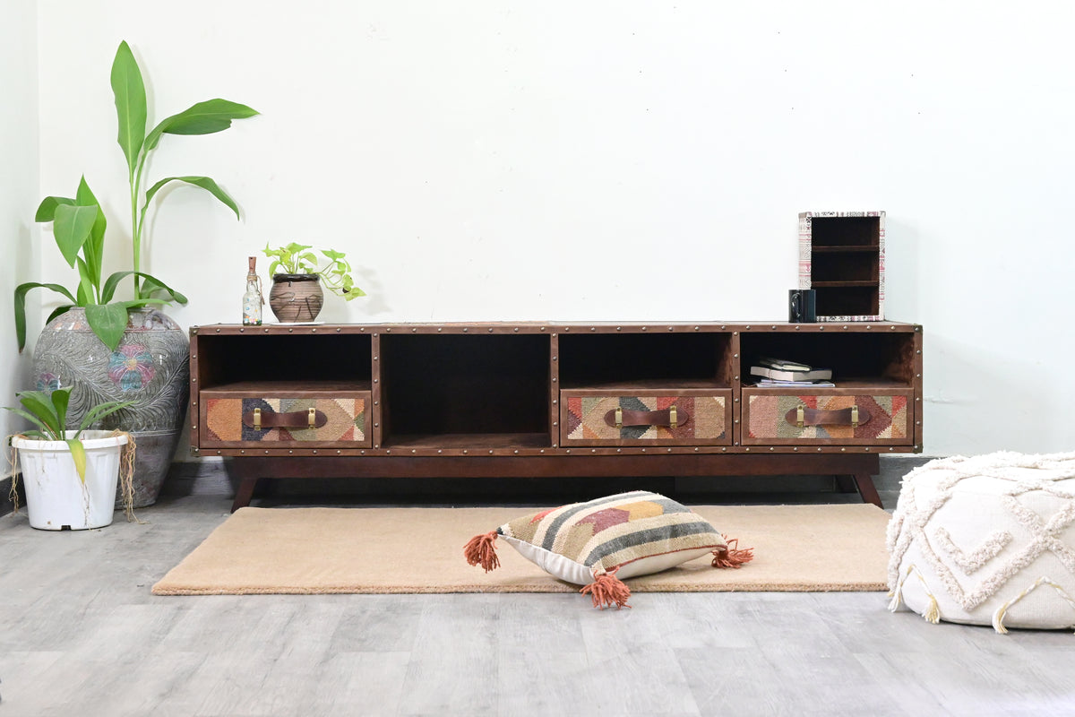 Ranakpur kilim and leather TV unit front view with open bays and three kilim drawers, styled without a television