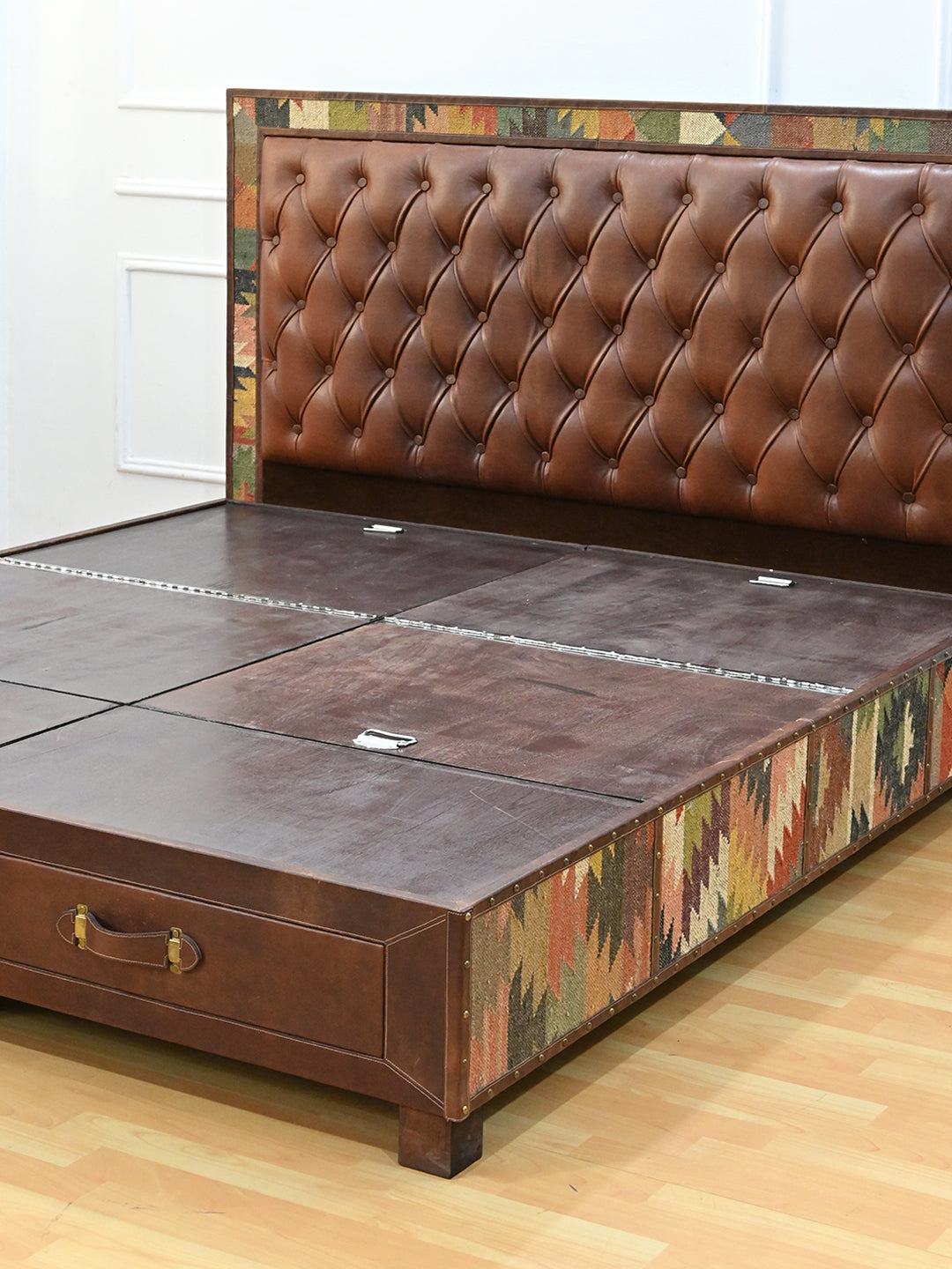 Narlai kilim and leather storage bed by Art Avenue, made to order — angled view of the platform and studded kilim side rail