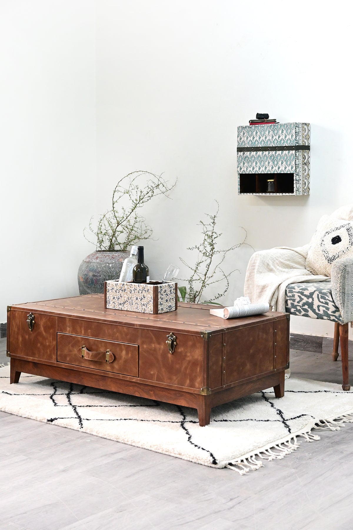 Kuchaman leather trunk coffee table at an angle, showing the studded top and end straps — Art Avenue, made to order