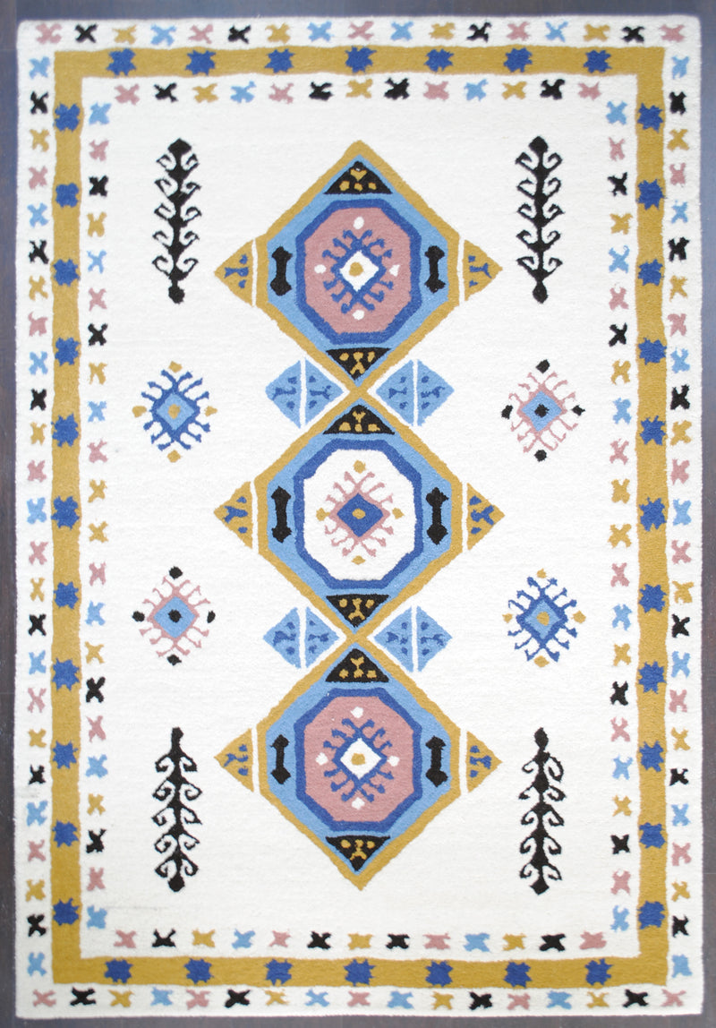 Tawang hand-tufted wool rug from above: three blush and sky-blue medallions on an ivory field, framed by a mustard band of cobalt stars