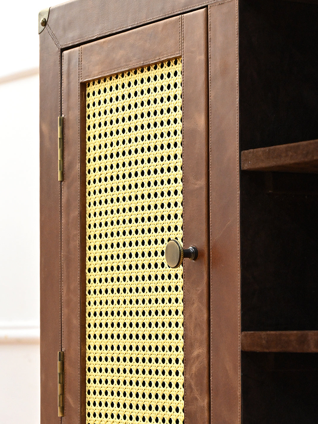 Detail of a leather-framed cane door with brass knob and exposed hinge, Fatehpur sideboard, Art Avenue