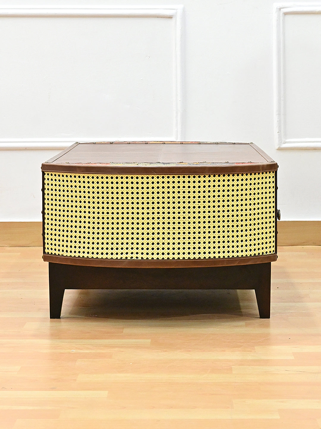 End elevation of the Bisalpur coffee table, full curved woven cane panel in a leather frame