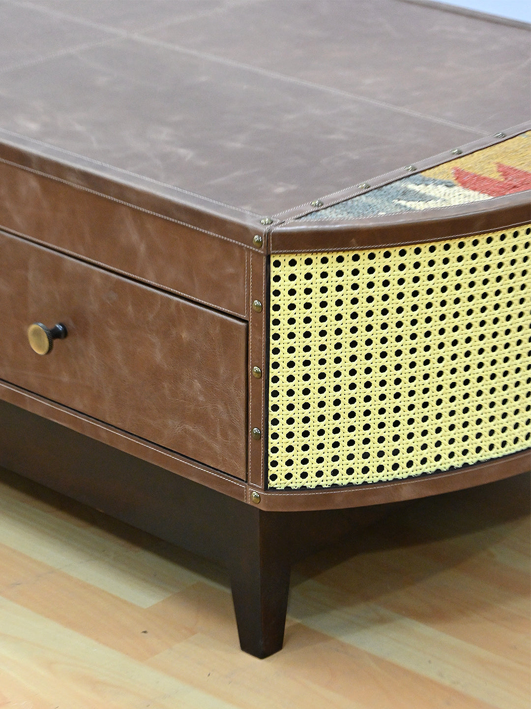 Corner detail of the Bisalpur coffee table, hand-driven domed studs along the leather seams