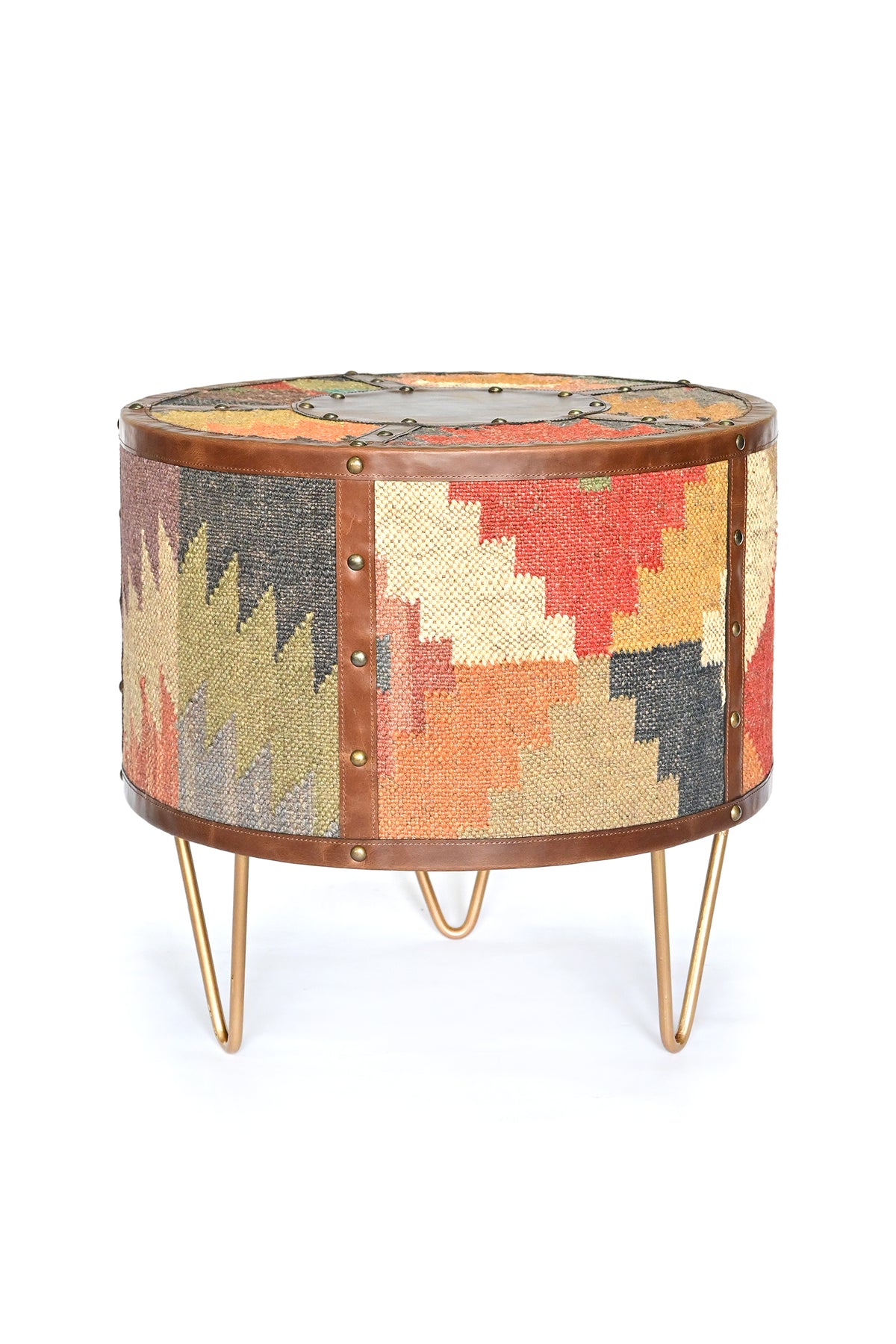 Alwar kilim side table side view: kilim panels between studded leather straps on gold hairpin legs
