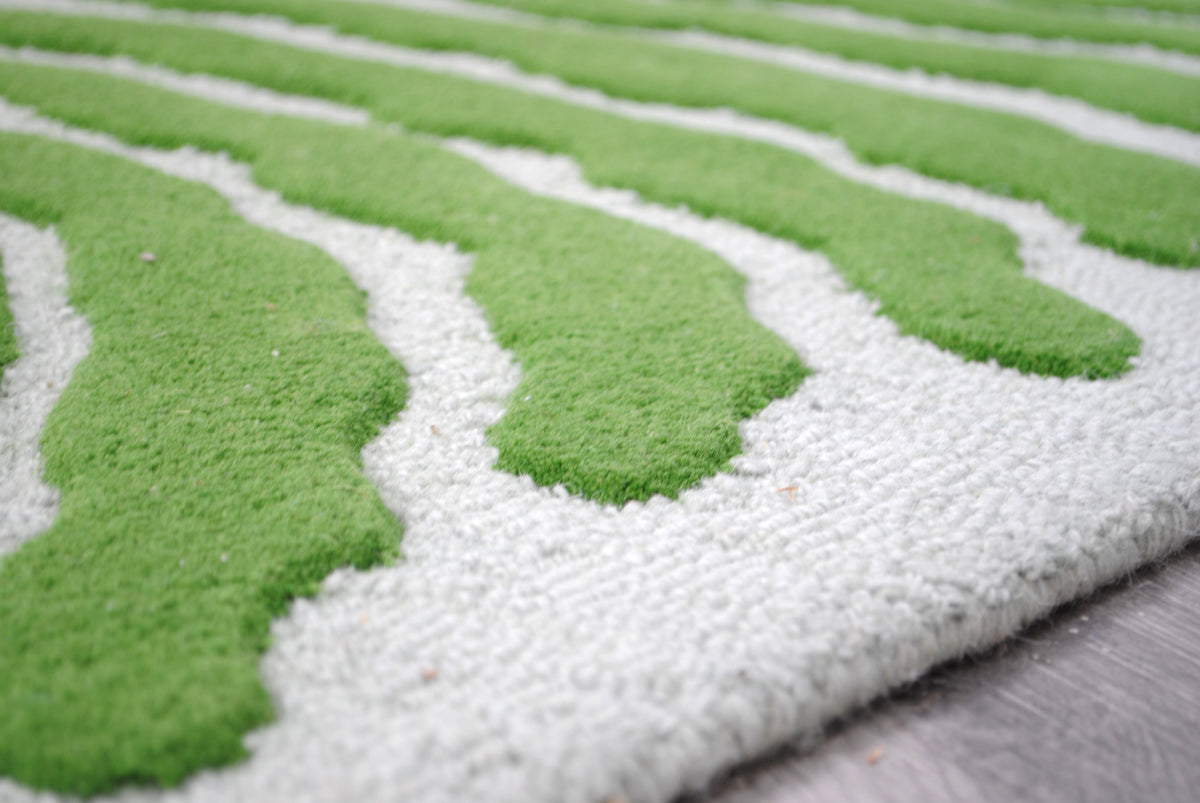 Close-up of the Munnar rug's raised green cut pile against the pale mint loop-pile ground
