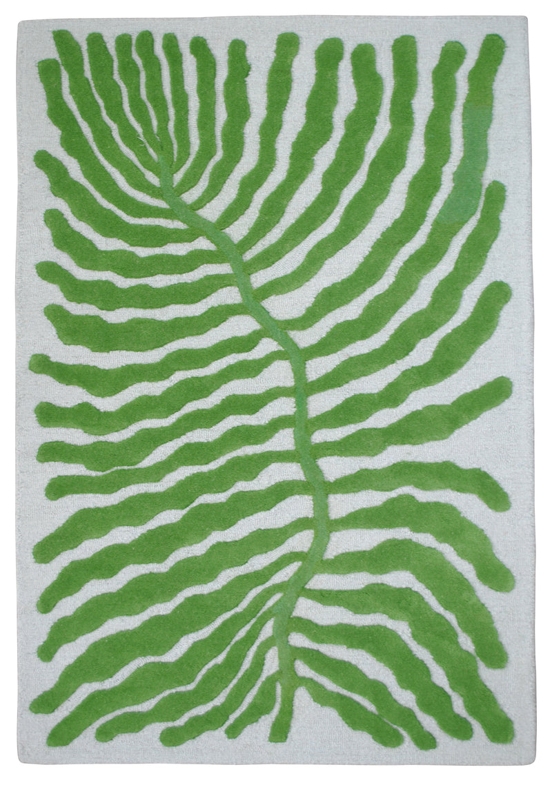Munnar hand-tufted wool rug from above: one oversized green leaf with wavy fronds on a pale mint ground, no border