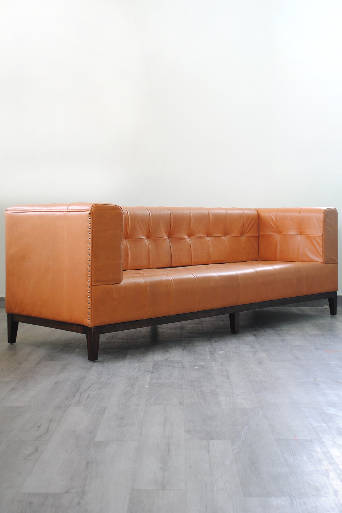 Santiago tan leather sofa in three-quarter view, showing track arms level with the back
