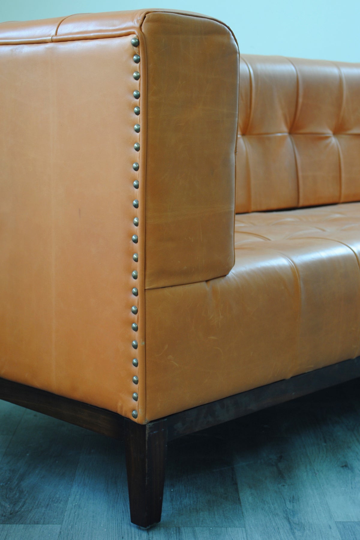 Corner detail of the Santiago leather sofa with hand-set antique brass nailhead trim