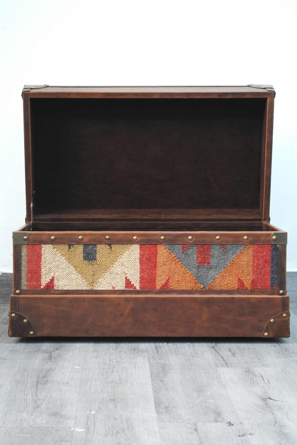 Bundi kilim steamer trunk with the lid open, showing the suede-lined interior