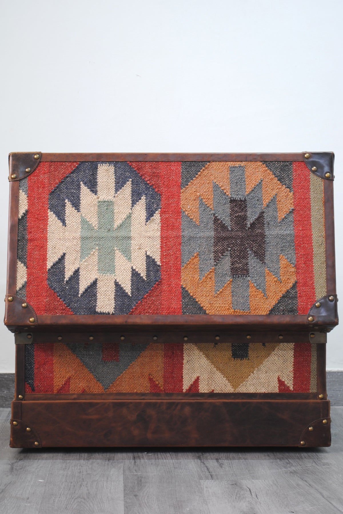 Bundi kilim steamer trunk with the lid raised, showing the kilim medallions woven into the lid panel