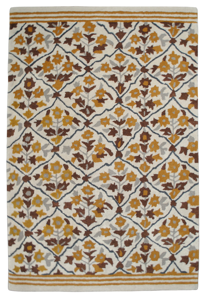 Sikandra hand-tufted wool rug from above: a Mughal flowering trellis in ochre, saffron and chocolate brown on ivory, with ochre stripe bands at each end