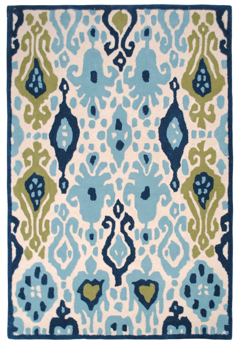 Pochampally hand-tufted wool rug from above: sky-blue, indigo and moss-green ikat motifs on an ivory ground with an indigo edge
