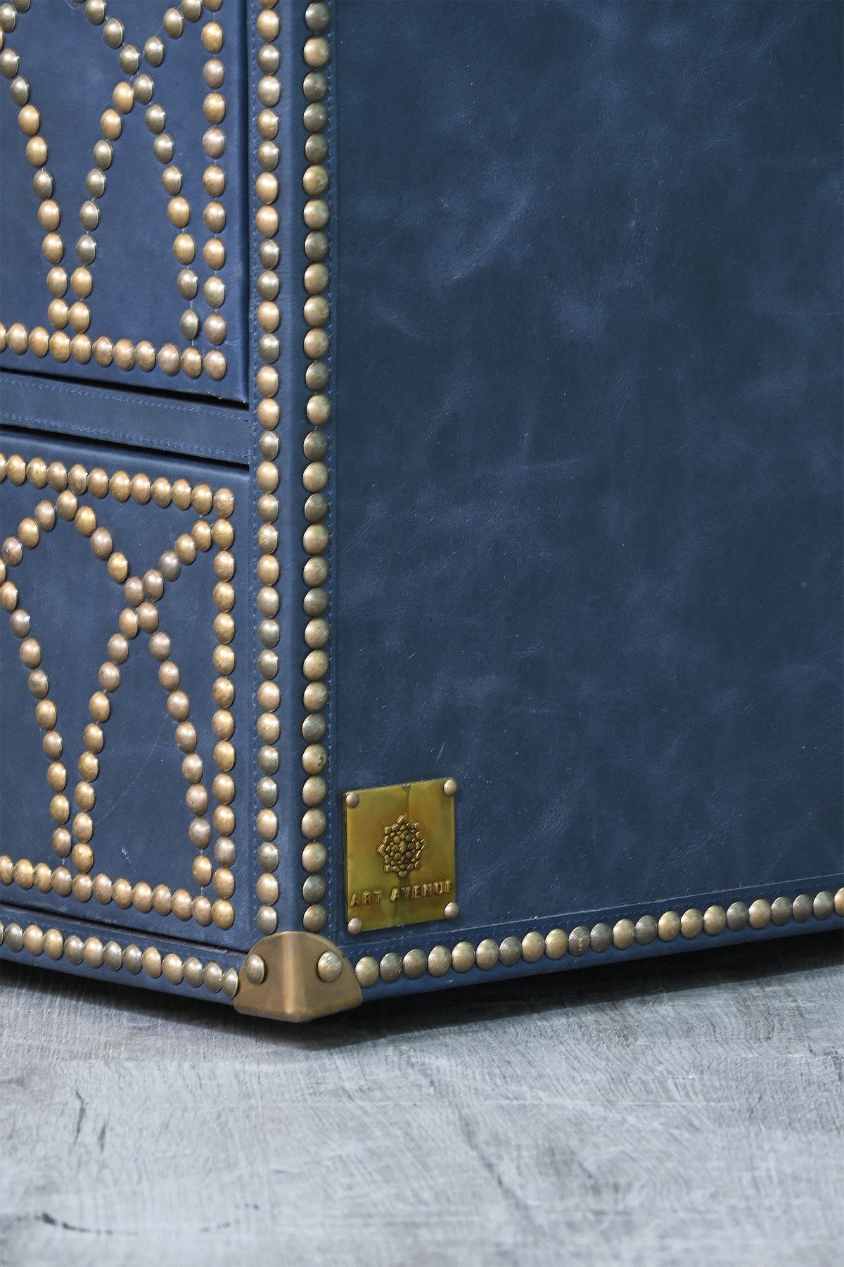 Detail of the cast brass corner cap and Art Avenue brass maker's plate on the Samode bedside chest