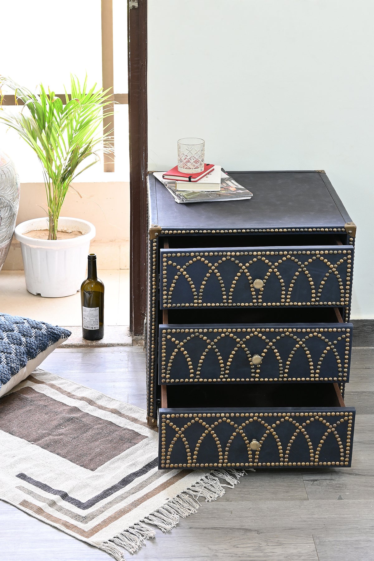 Samode leather bedside chest with its three drawers extended on ball-bearing runners