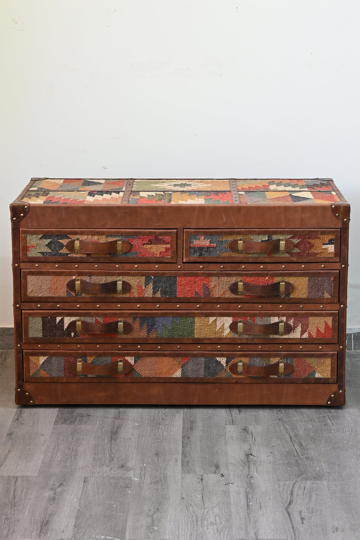 Front view of the Chittor campaign chest with vintage kilim inset into the lid and all five drawer fronts