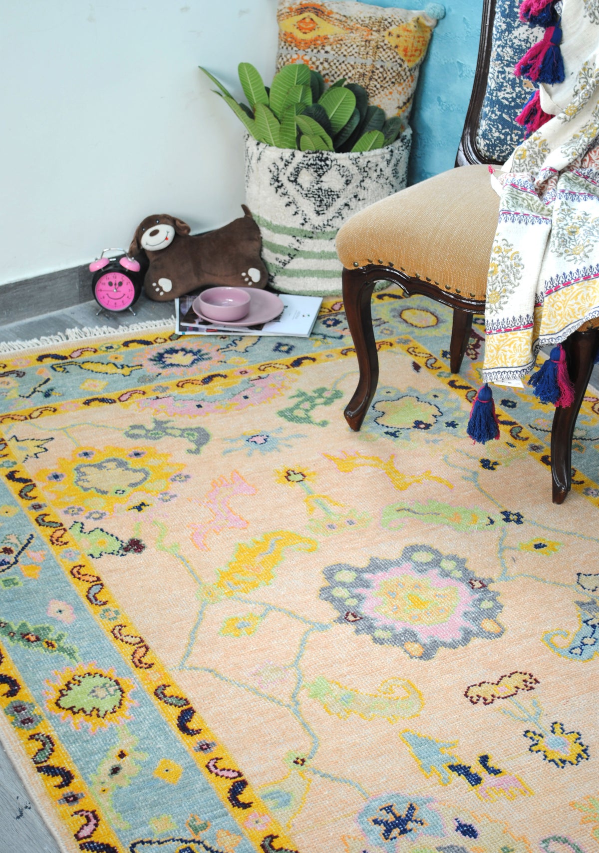 Close room view of the Mysore Hand-Knotted Rug showing the slate and pink centre medallion and pale-blue vine — Art Avenue