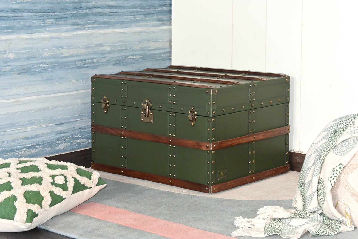 Neemrana leather trunk in a room corner beside a tufted cushion and block-printed throw — Art Avenue