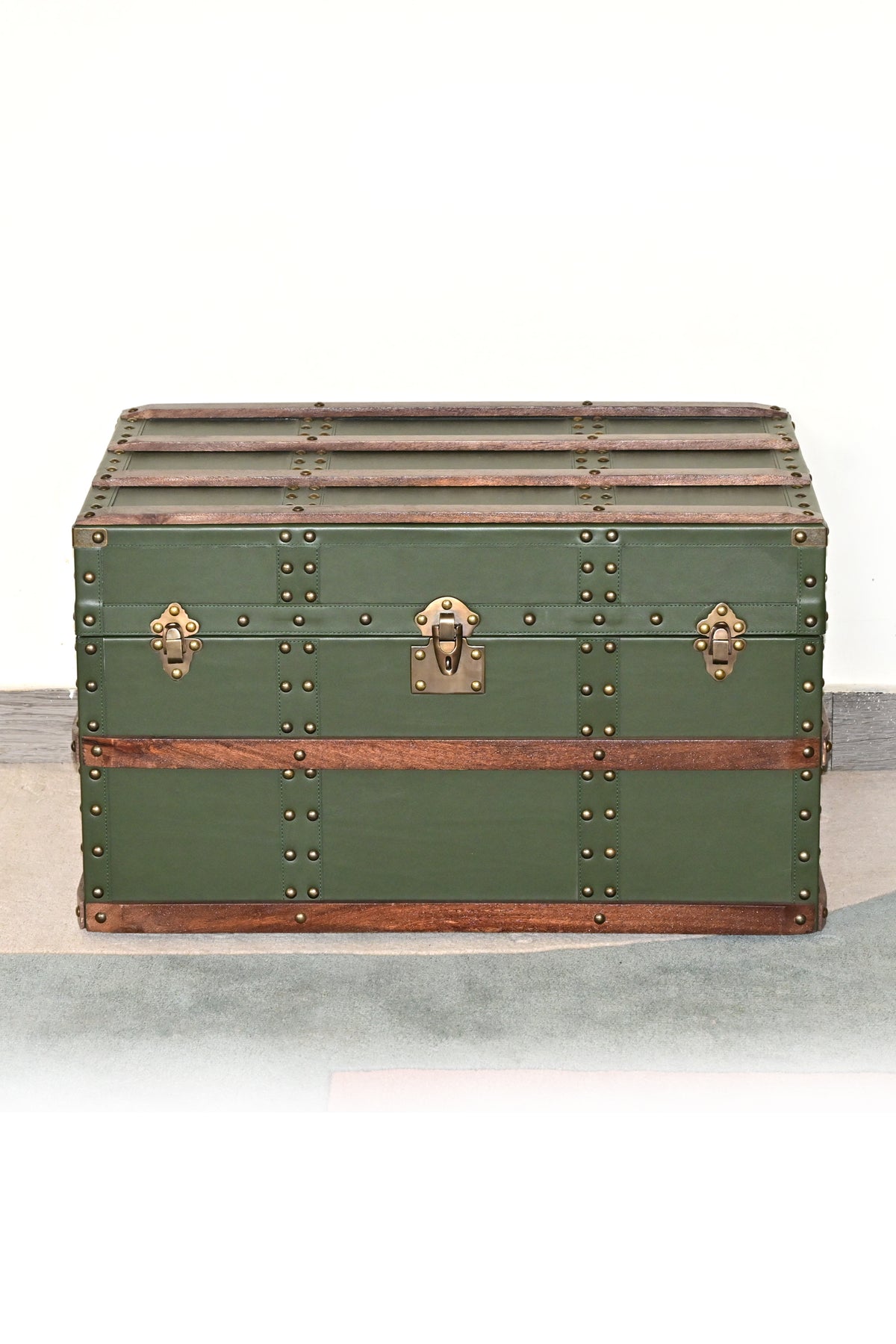 Neemrana leather steamer trunk in green leather with wood bands and antique brass catches, front view — Art Avenue, made to order