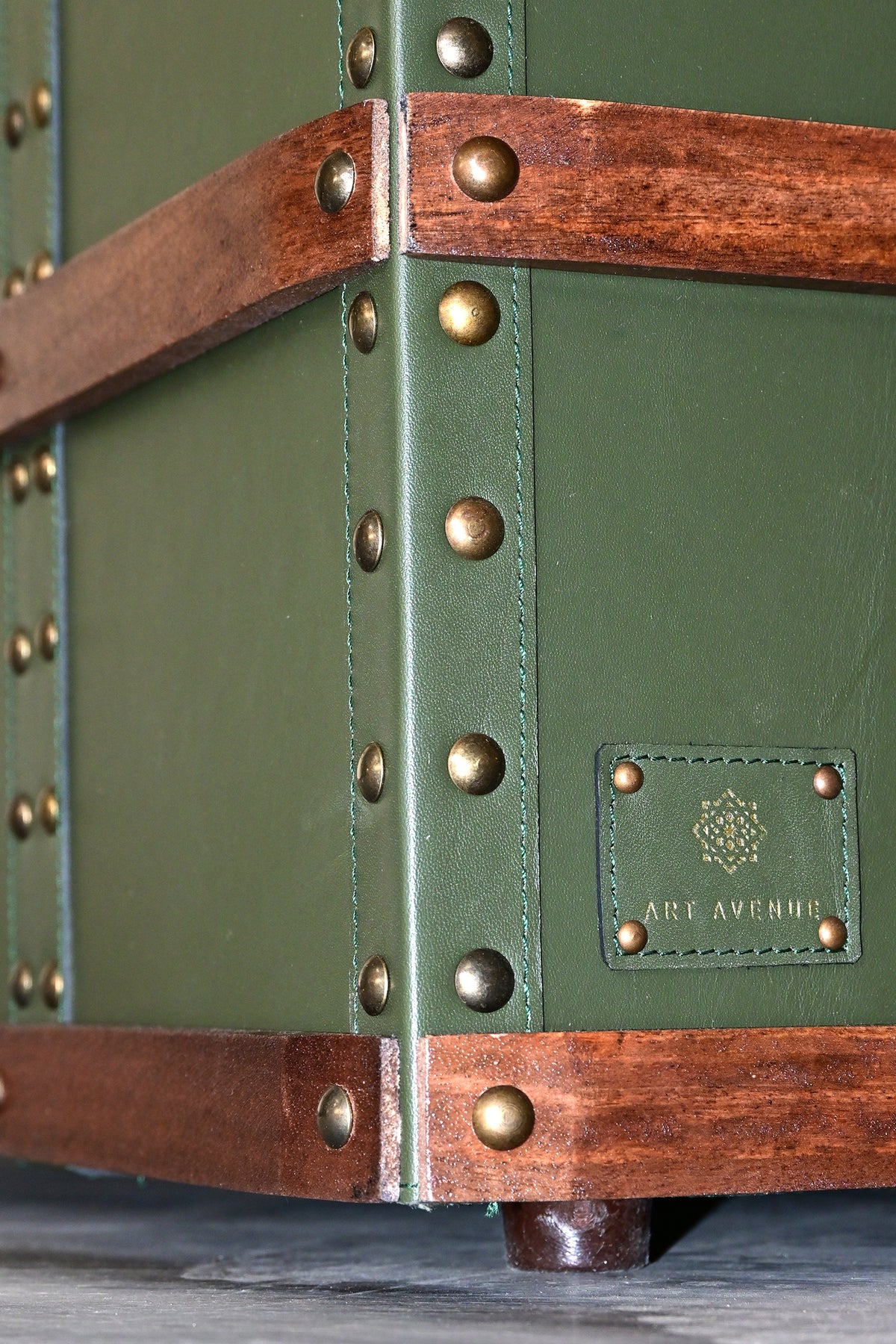 Base corner detail with stitched leather, maker's label and turned wooden foot — Art Avenue