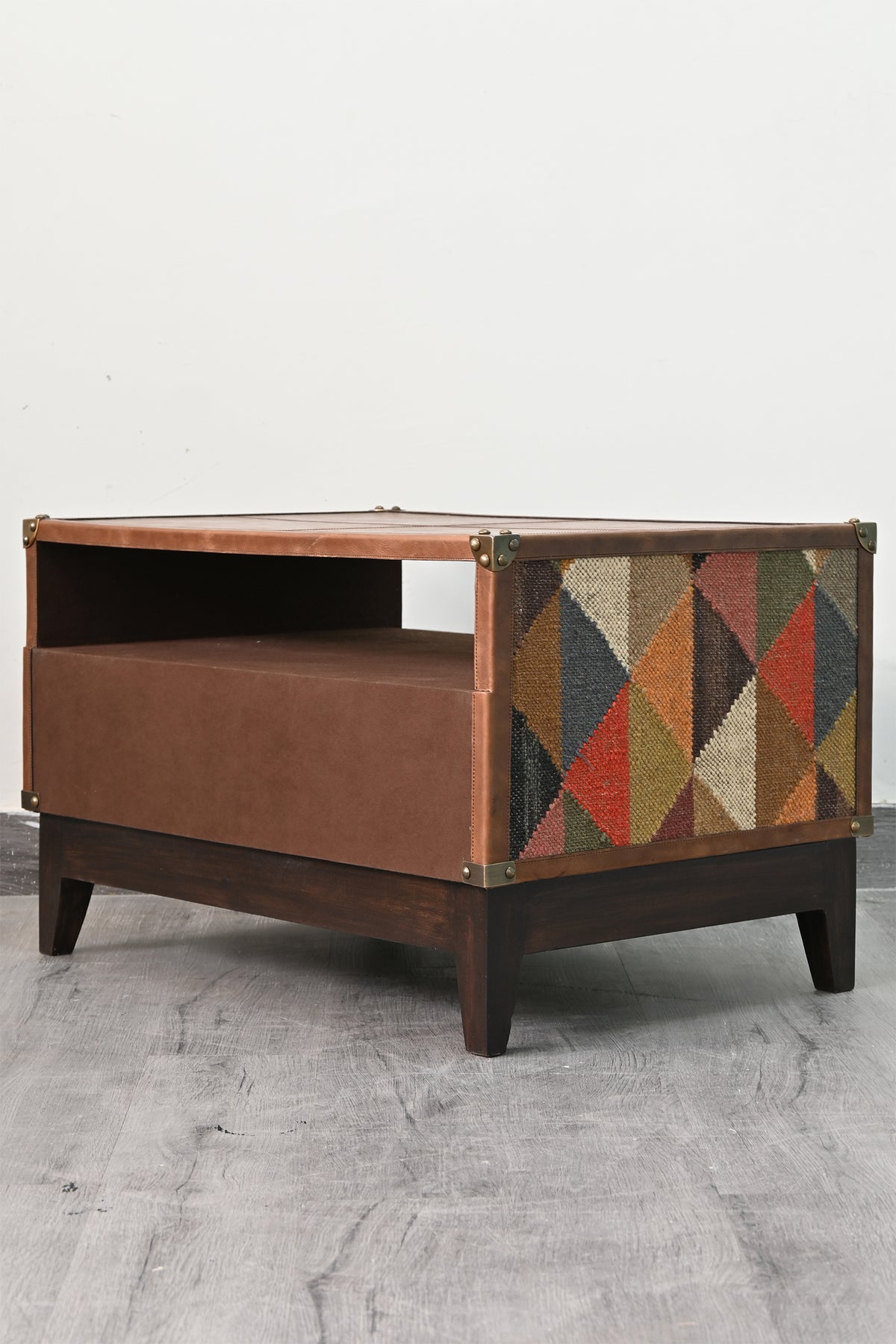 Barmer TV unit from the side, kilim flank panel above tapered solid wood legs