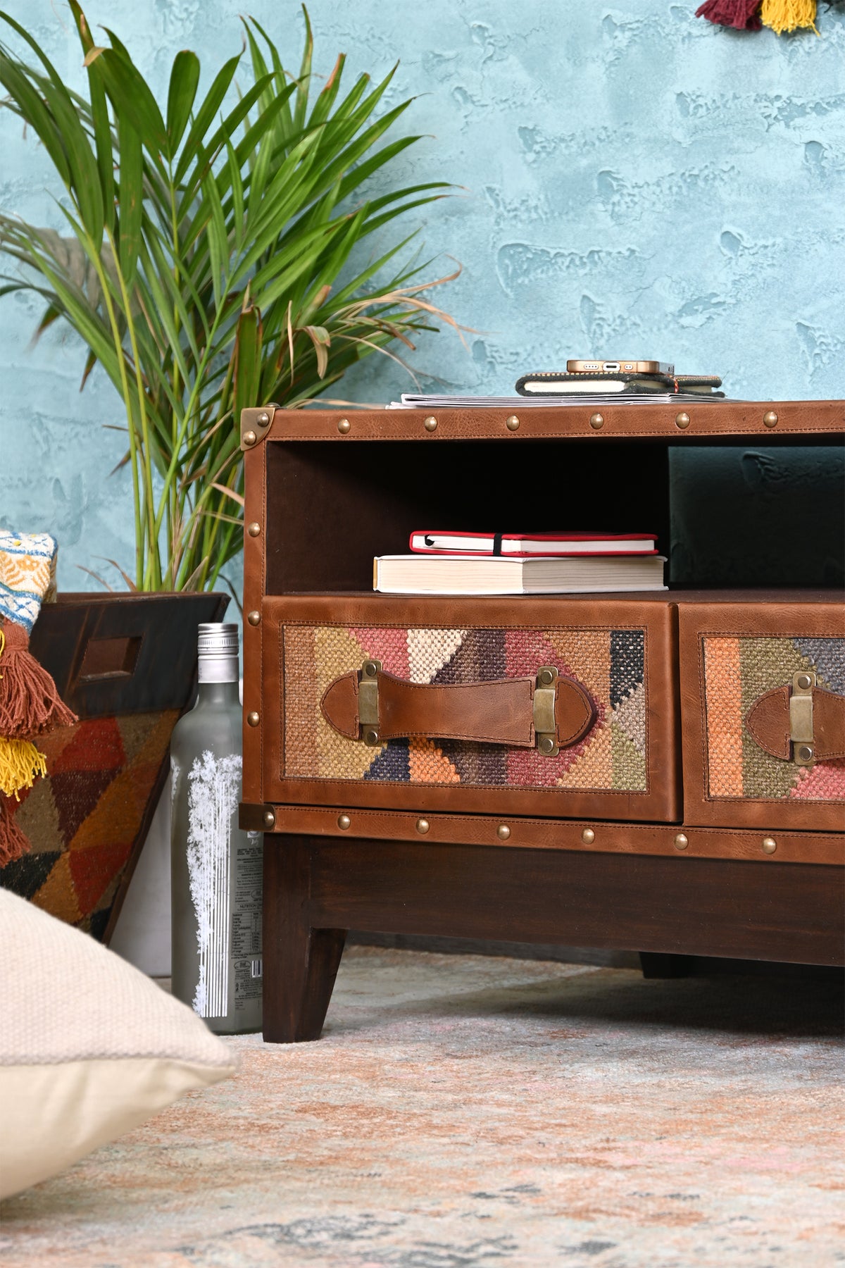 Barmer TV unit styled with books and a plant, the open bay in use