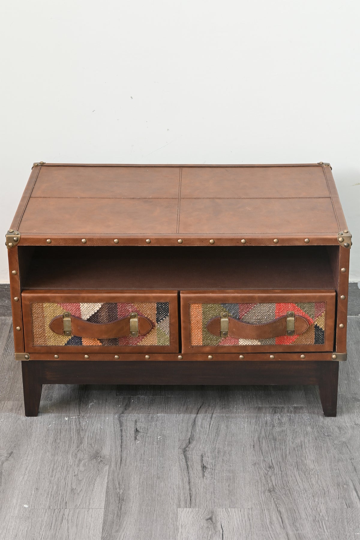 Leather top and front of the Barmer TV unit, showing stitched panel seams and hand-set domed studs