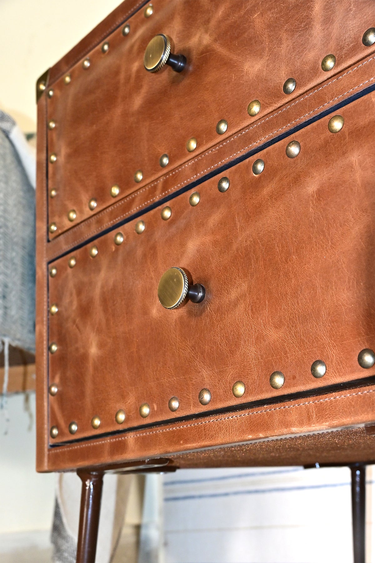 Detail of knurled brass knobs and hand-set studs on leather drawer fronts, Kishangarh bedside table, Art Avenue