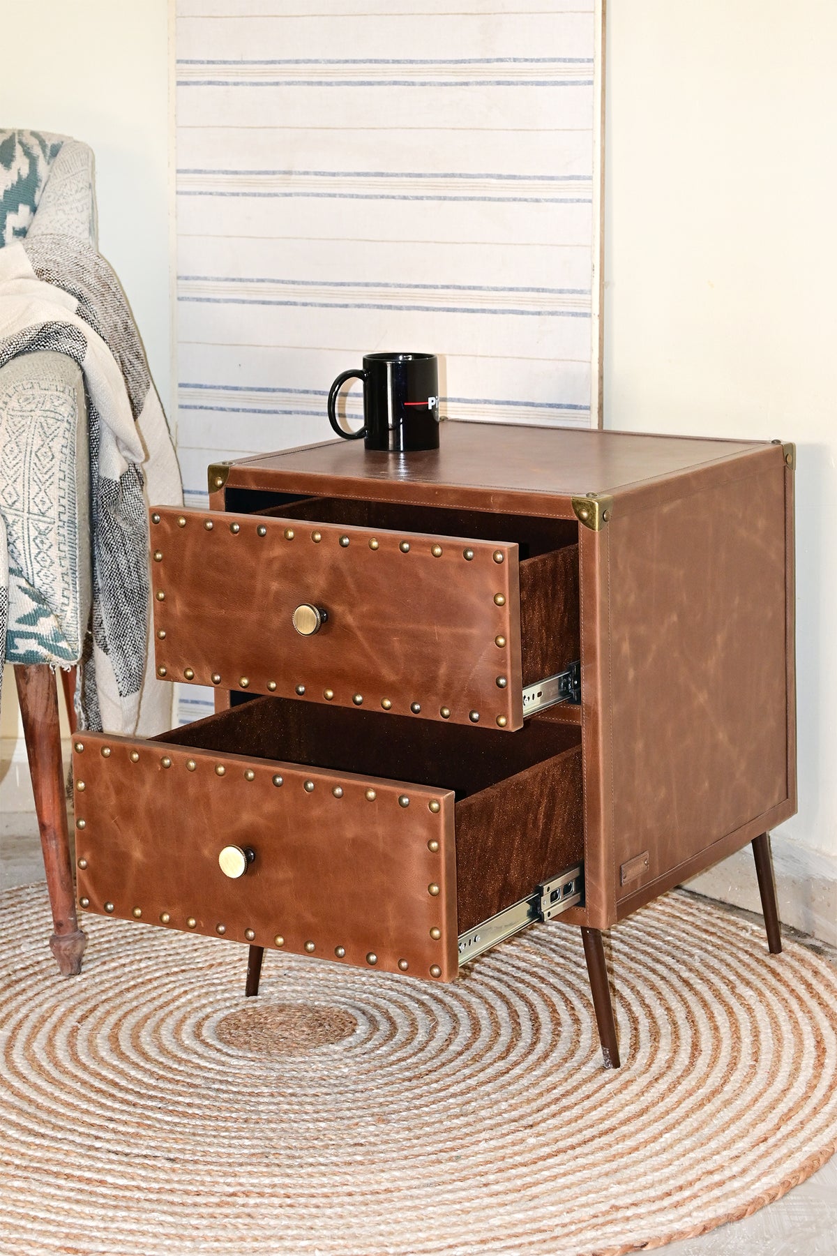 Kishangarh leather bedside table, drawers open, styled beside an armchair, Art Avenue