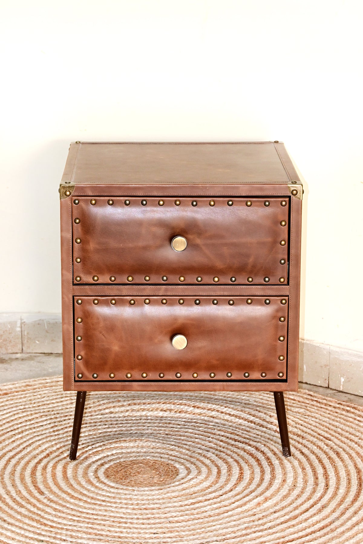 Kishangarh studded leather bedside table, front view, two drawers with brass stud borders, Art Avenue, made to order