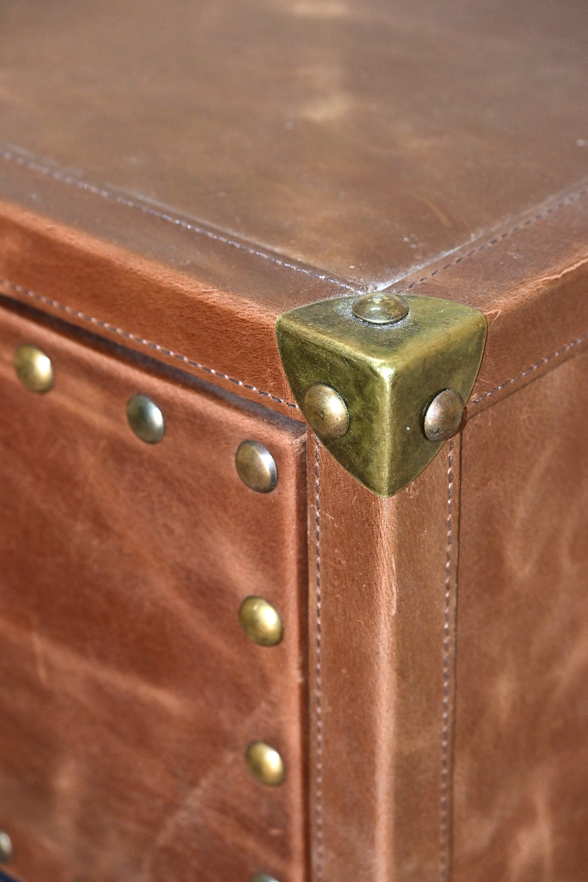 Detail of cast brass corner cap and saddle-stitched leather edges, Kishangarh bedside table, Art Avenue