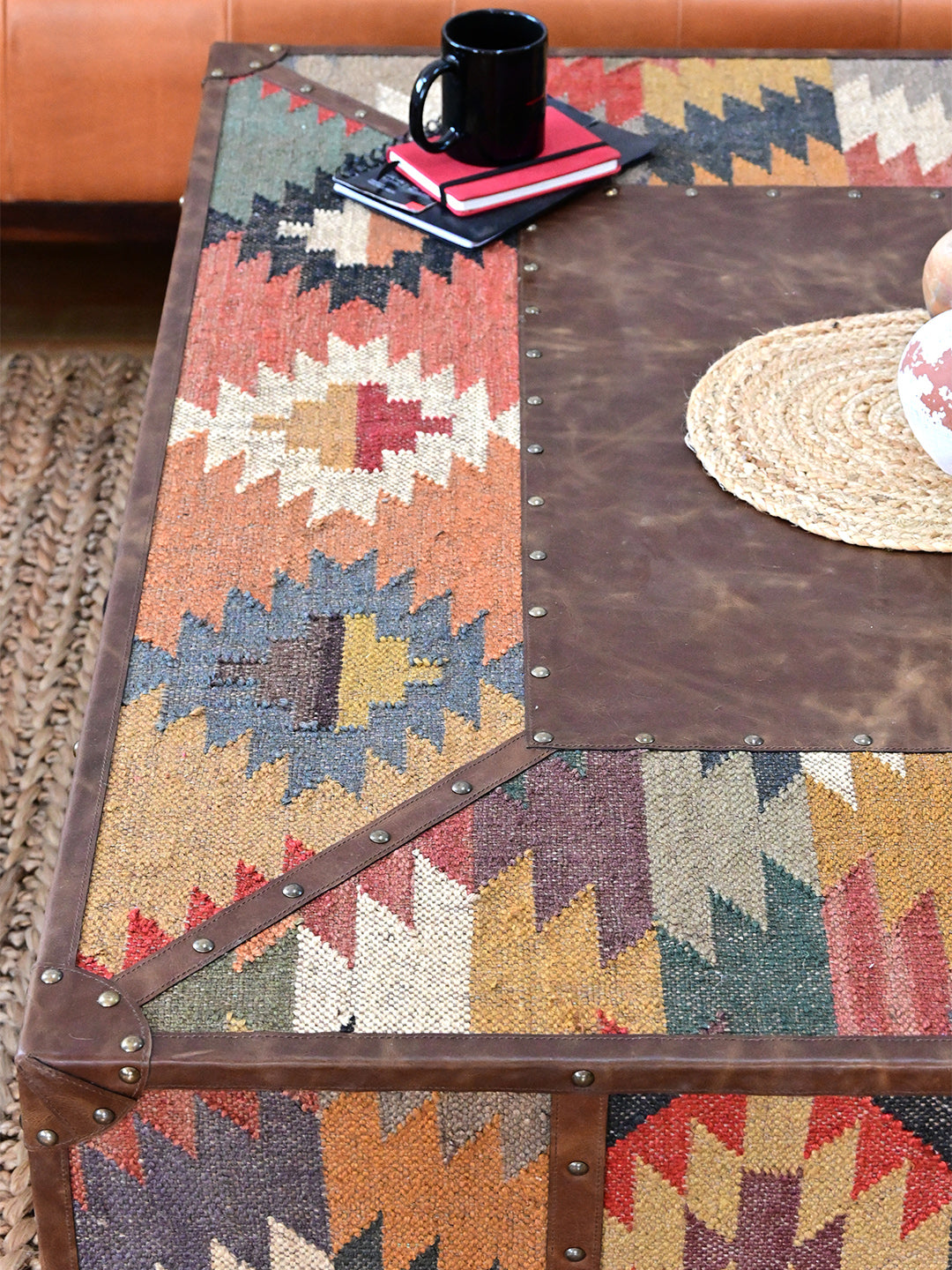 Styled top of the Mandawa coffee table, kilim border and leather centre panel with studded leather mitres, Art Avenue