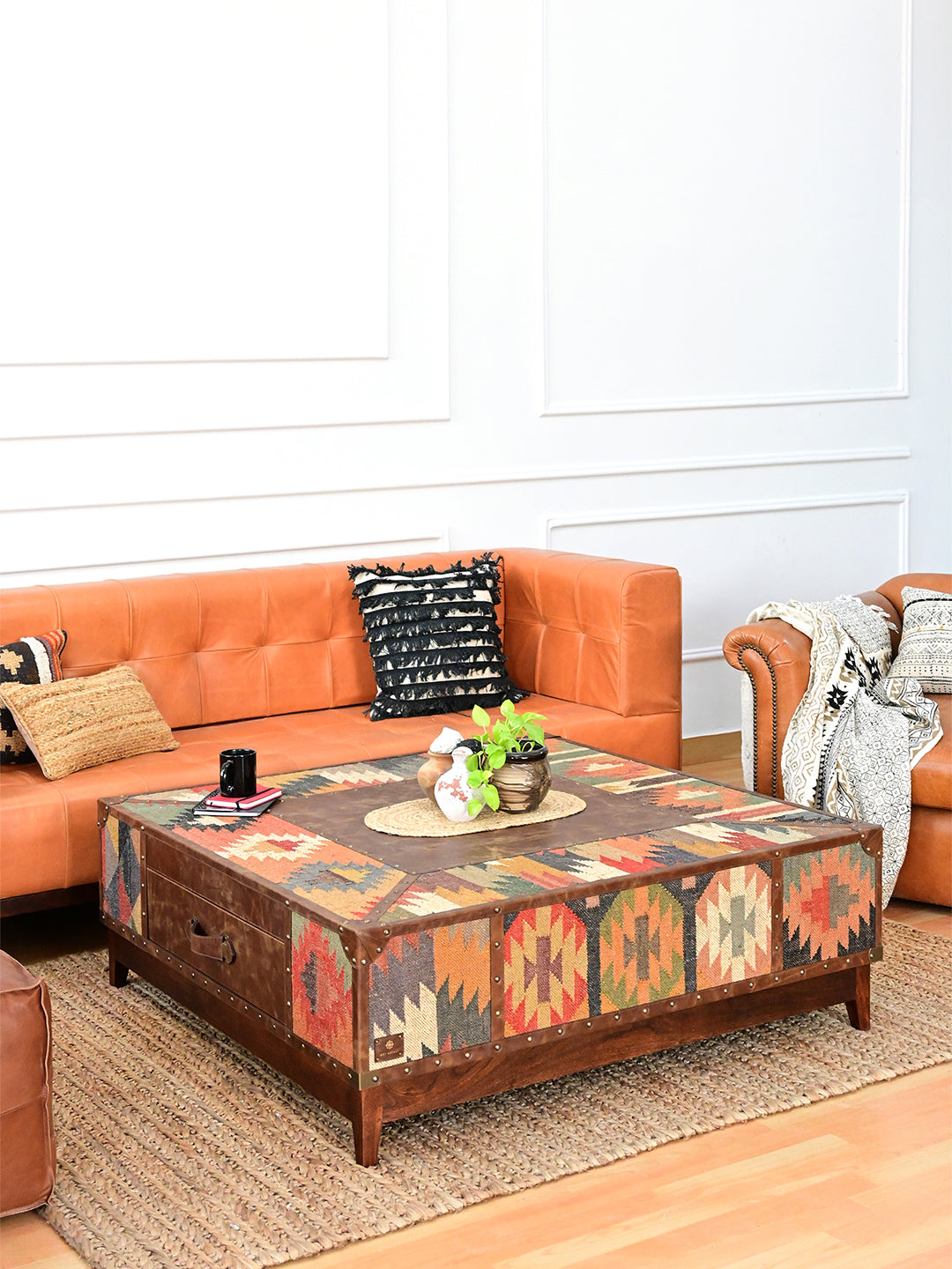 Mandawa 120 cm square kilim coffee table in front of a tan leather sofa, styled with a plant and tray, Art Avenue