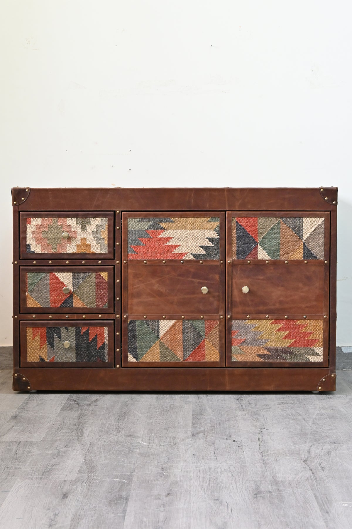 Front elevation of the Nimaj sideboard in hand-cut leather with vintage kilim drawer and door panels and brass knobs — Art Avenue