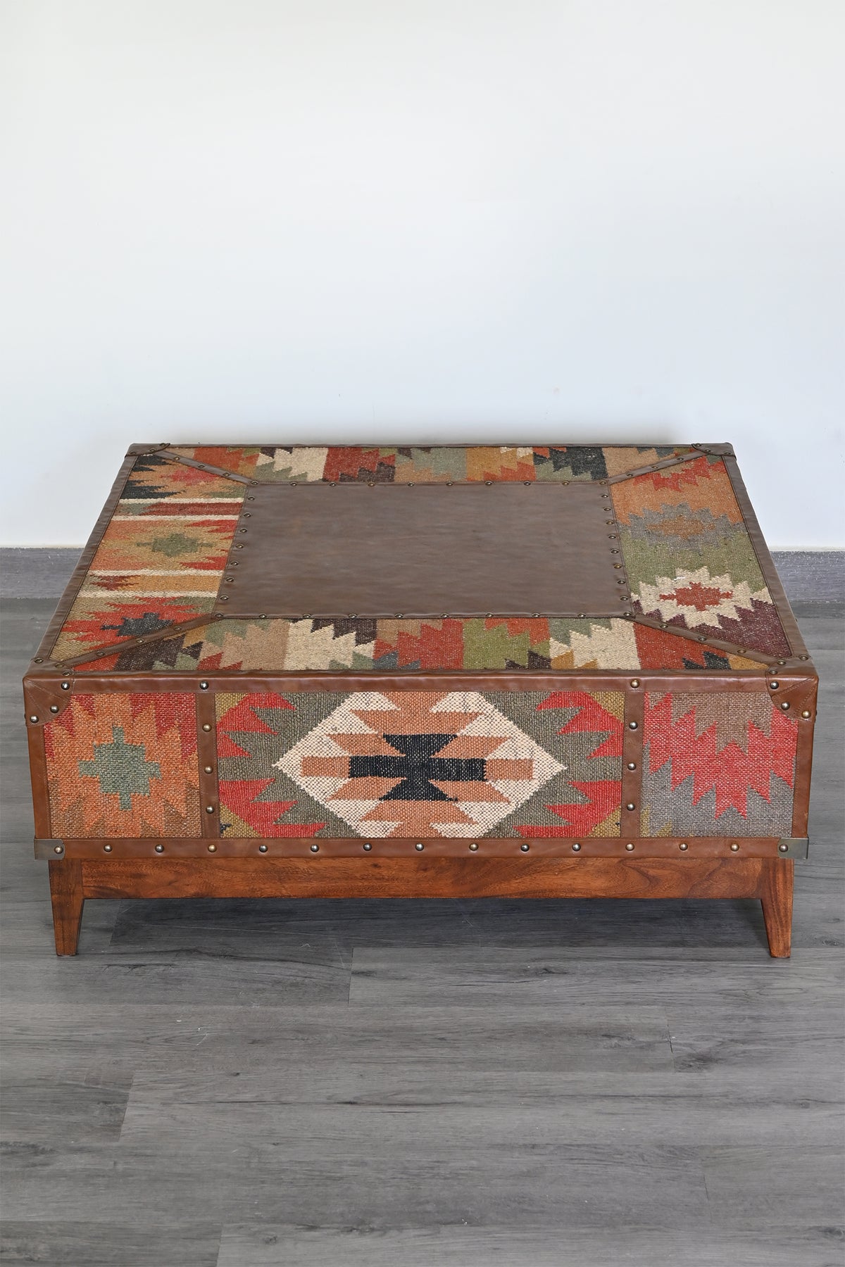 Raised three-quarter view showing the inset leather top panel of the Mandawa coffee table