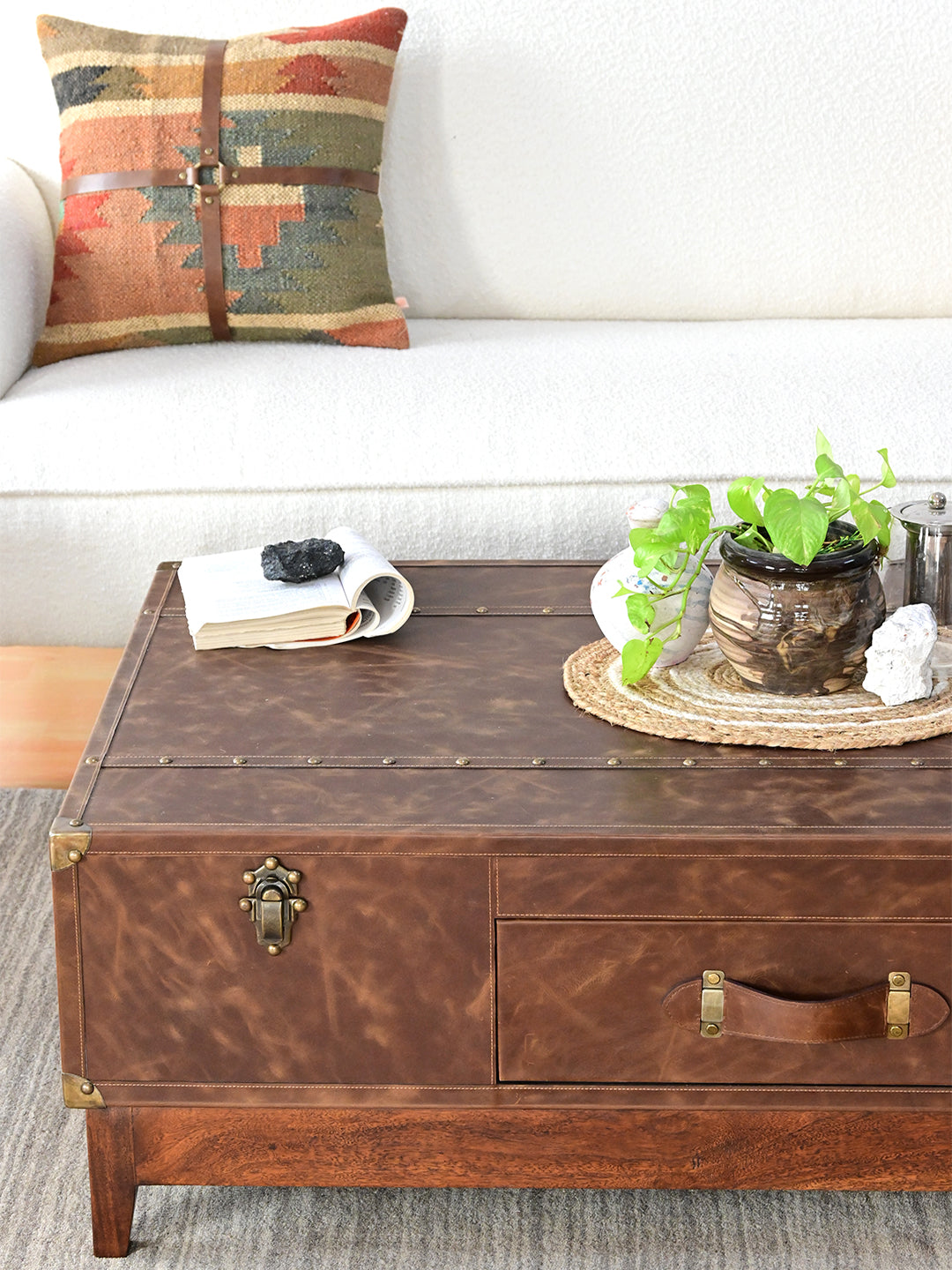 Nawalgarh leather trunk coffee table, detail of the studded top strap, trunk catch and stitched leather strap handle