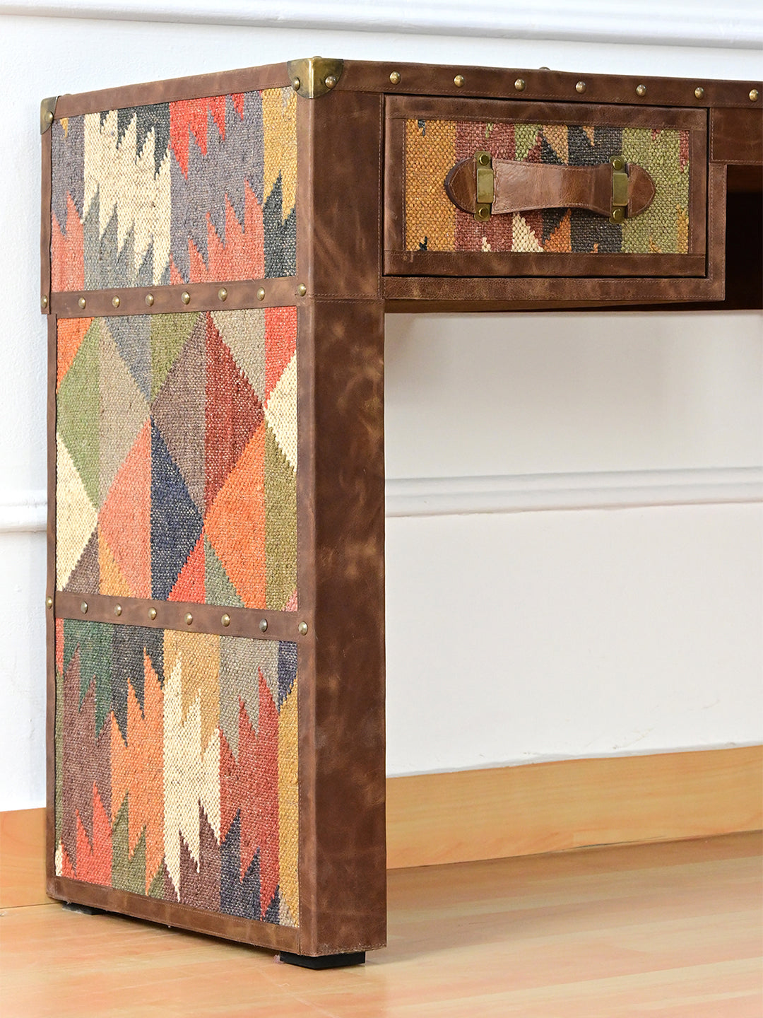 Outer leg of the Dungarpur desk, three kilim panels divided by studded leather bands