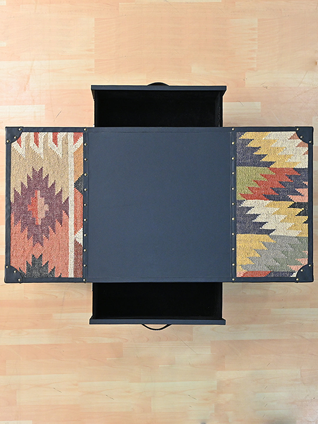 Overhead view of the Kumbhalgarh coffee table with both drawers open, one from each long side, between kilim top panels