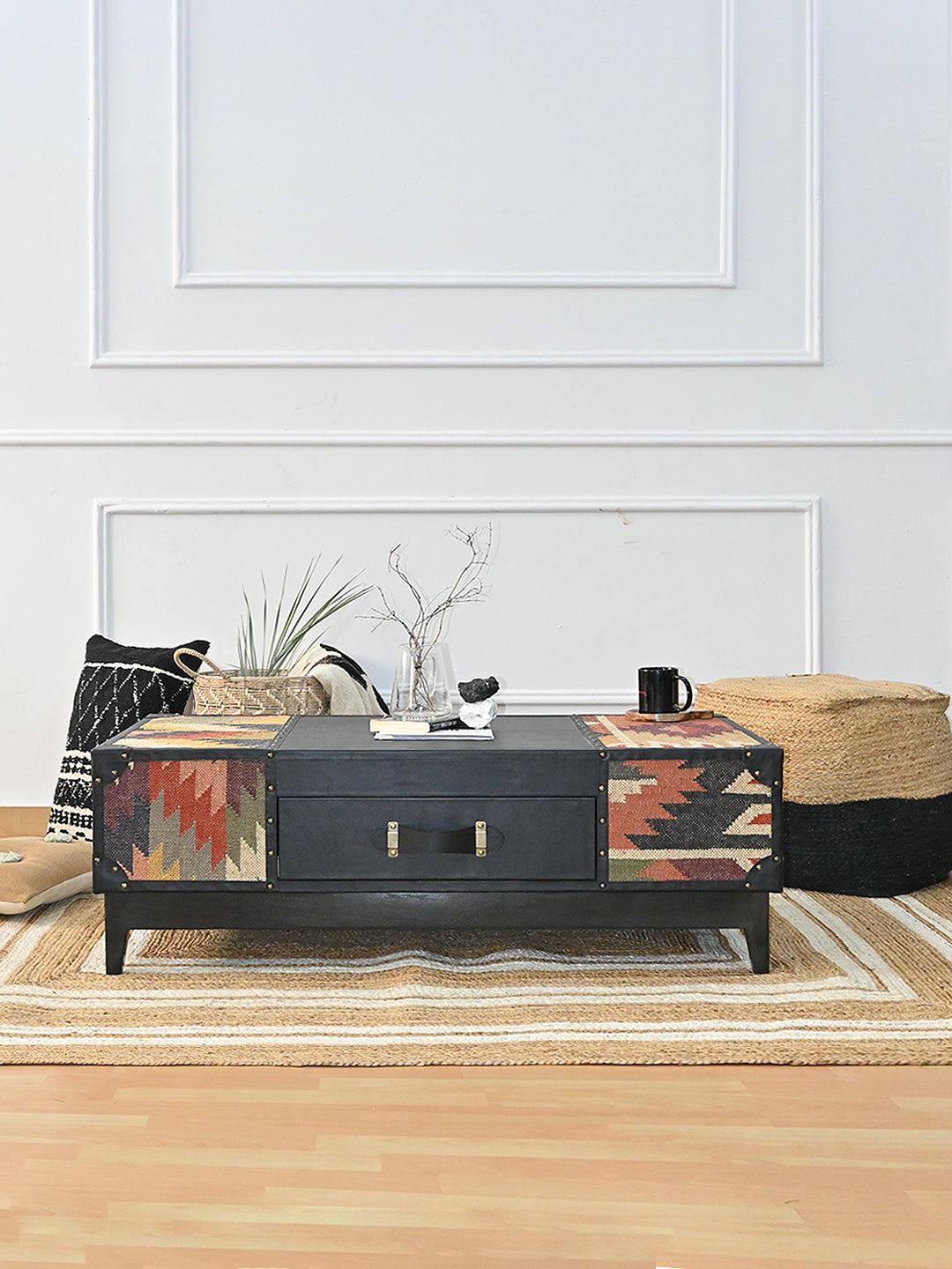 Kumbhalgarh coffee table by Art Avenue in a styled living room with a jute rug, patterned cushion, woven basket and pouf
