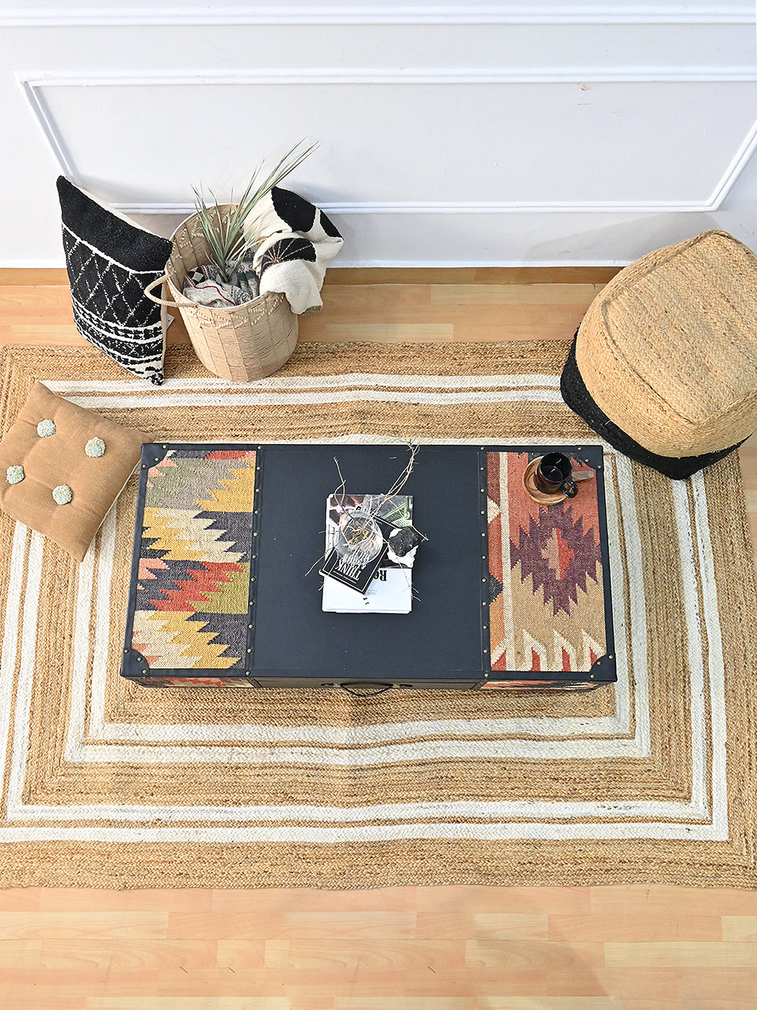 Overhead view of the Kumbhalgarh coffee table showing the three-panel top — kilim, black leather, kilim