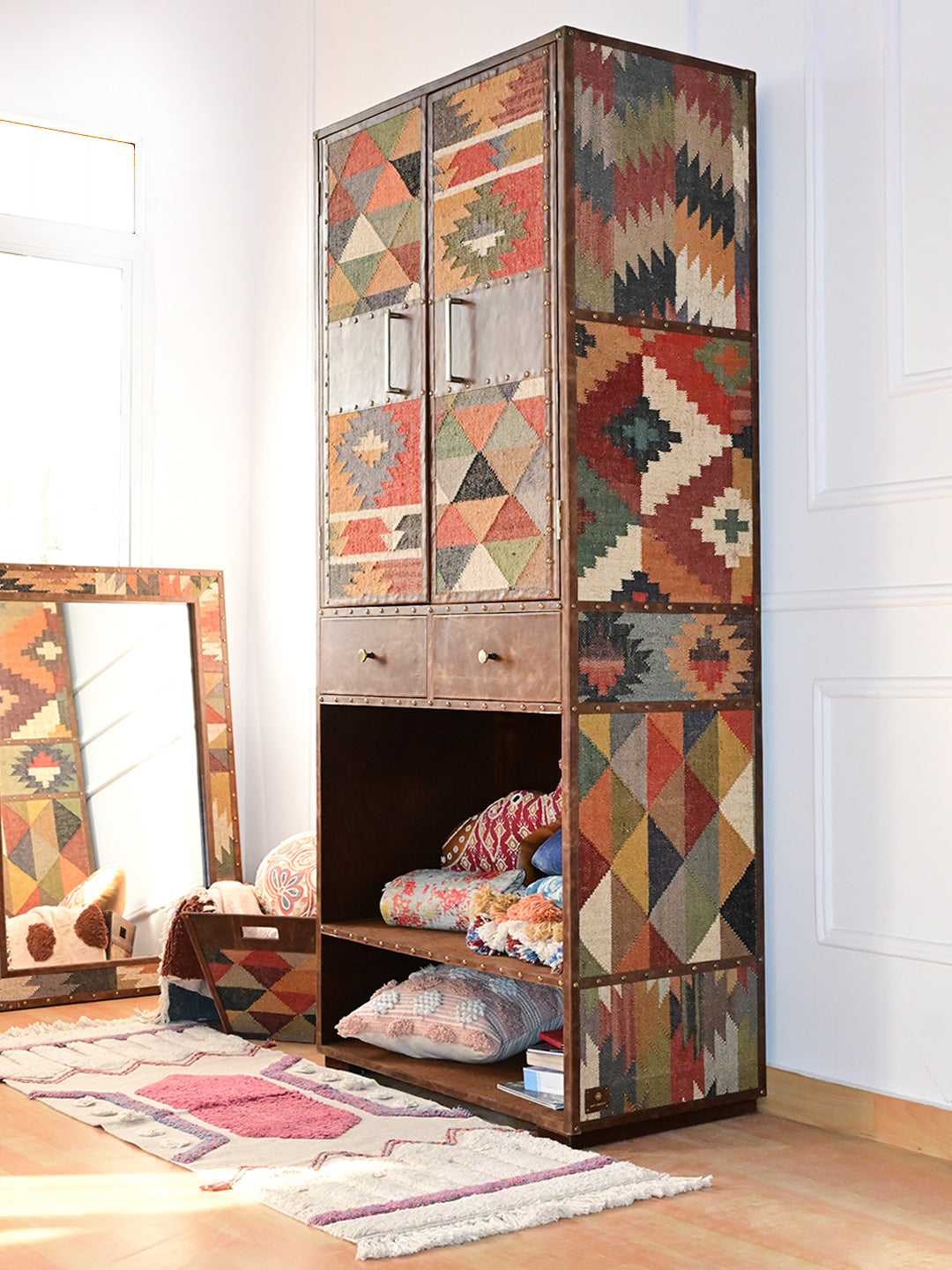 Alsisar kilim wardrobe styled in a sunlit room with folded throws in the open shelf bay, Art Avenue