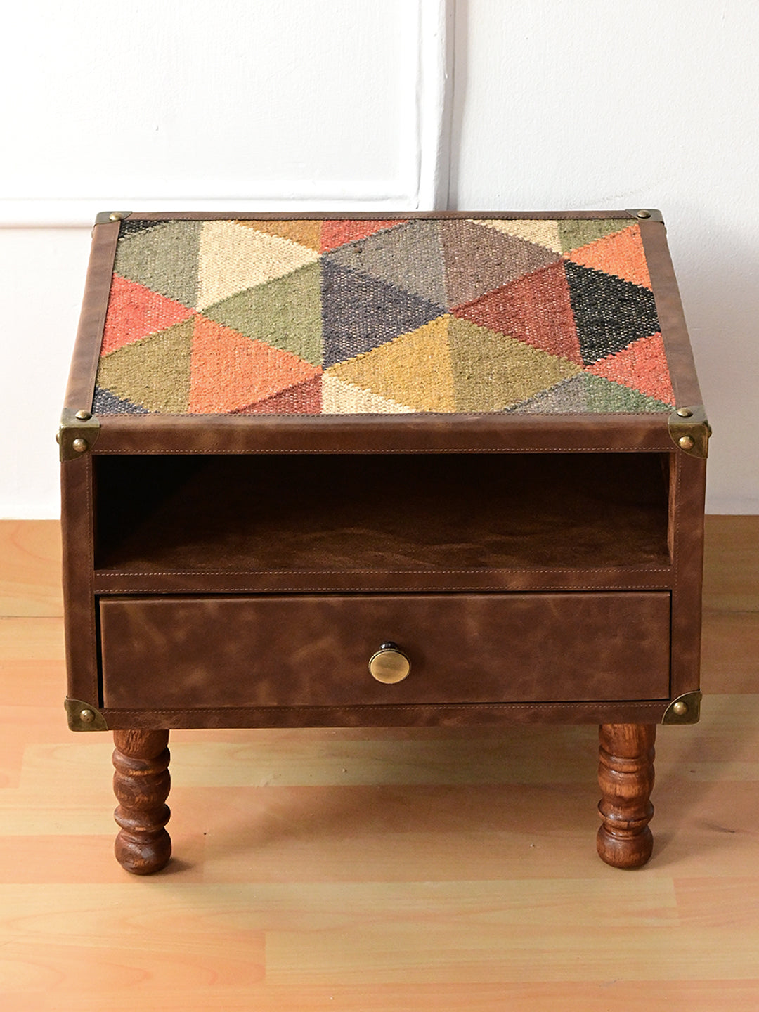 Mahansar bedside table from above, showing the vintage kilim top in a leather frame