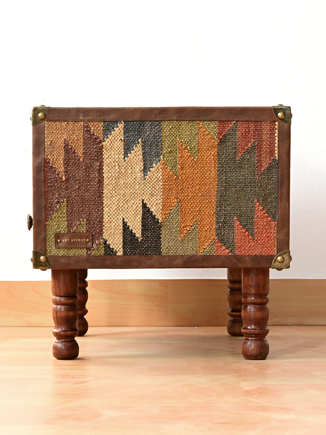 Side elevation of the Mahansar bedside table showing a full kilim panel and Art Avenue leather tag