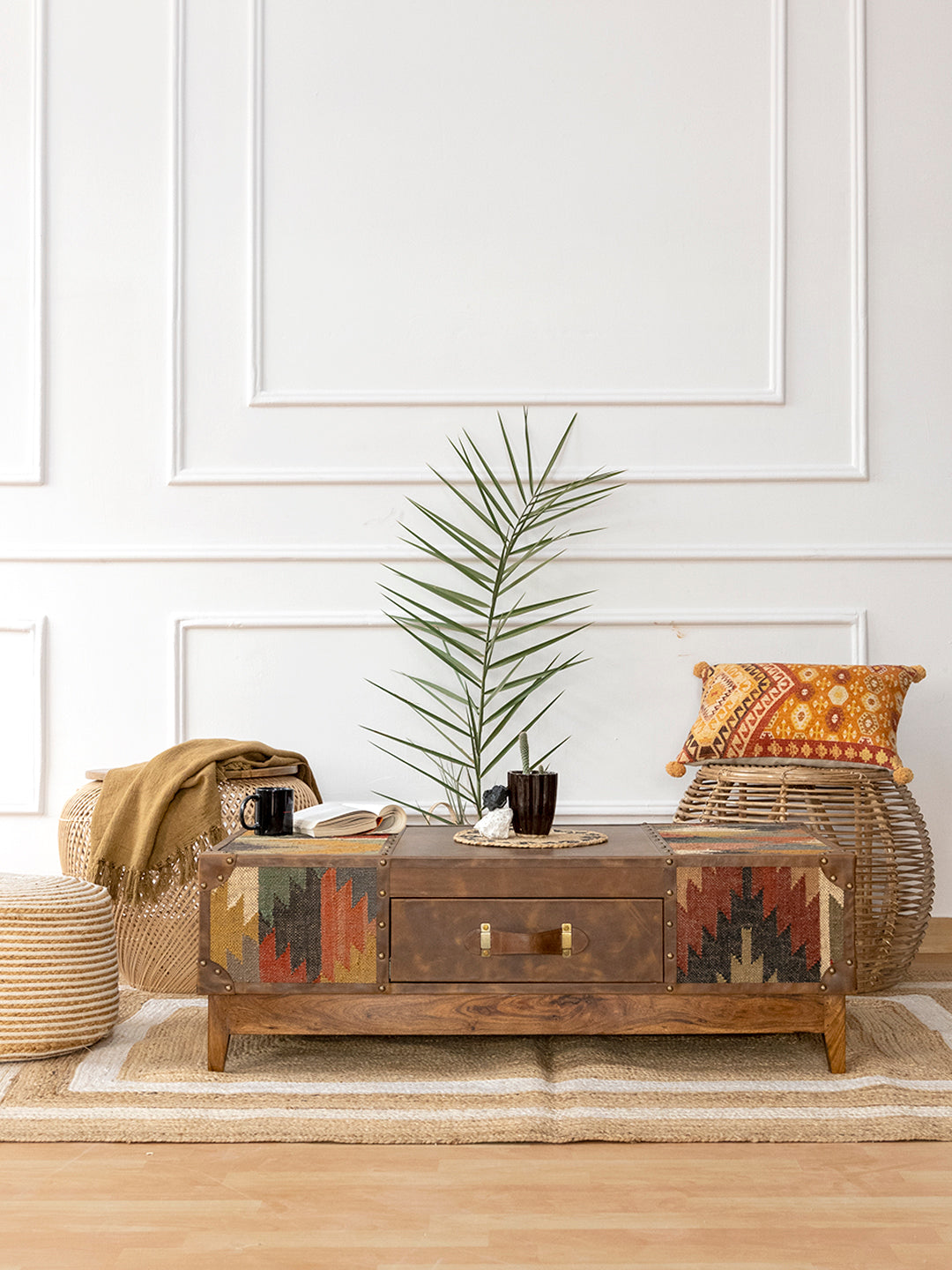 Sojat kilim and leather coffee table styled with rattan stools and a jute rug, by Art Avenue