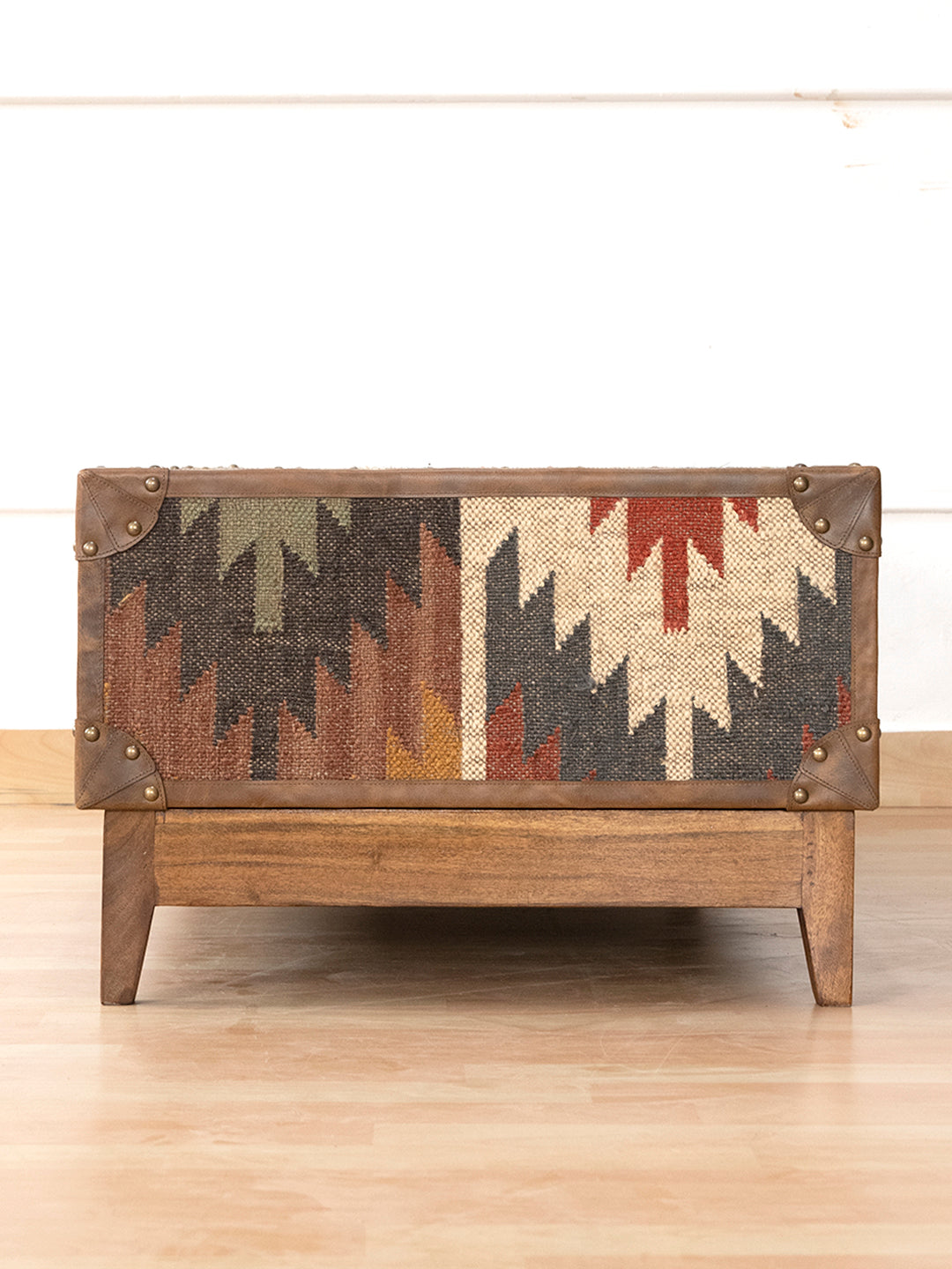Kilim-wrapped short end of the Sojat coffee table with leather binding, by Art Avenue