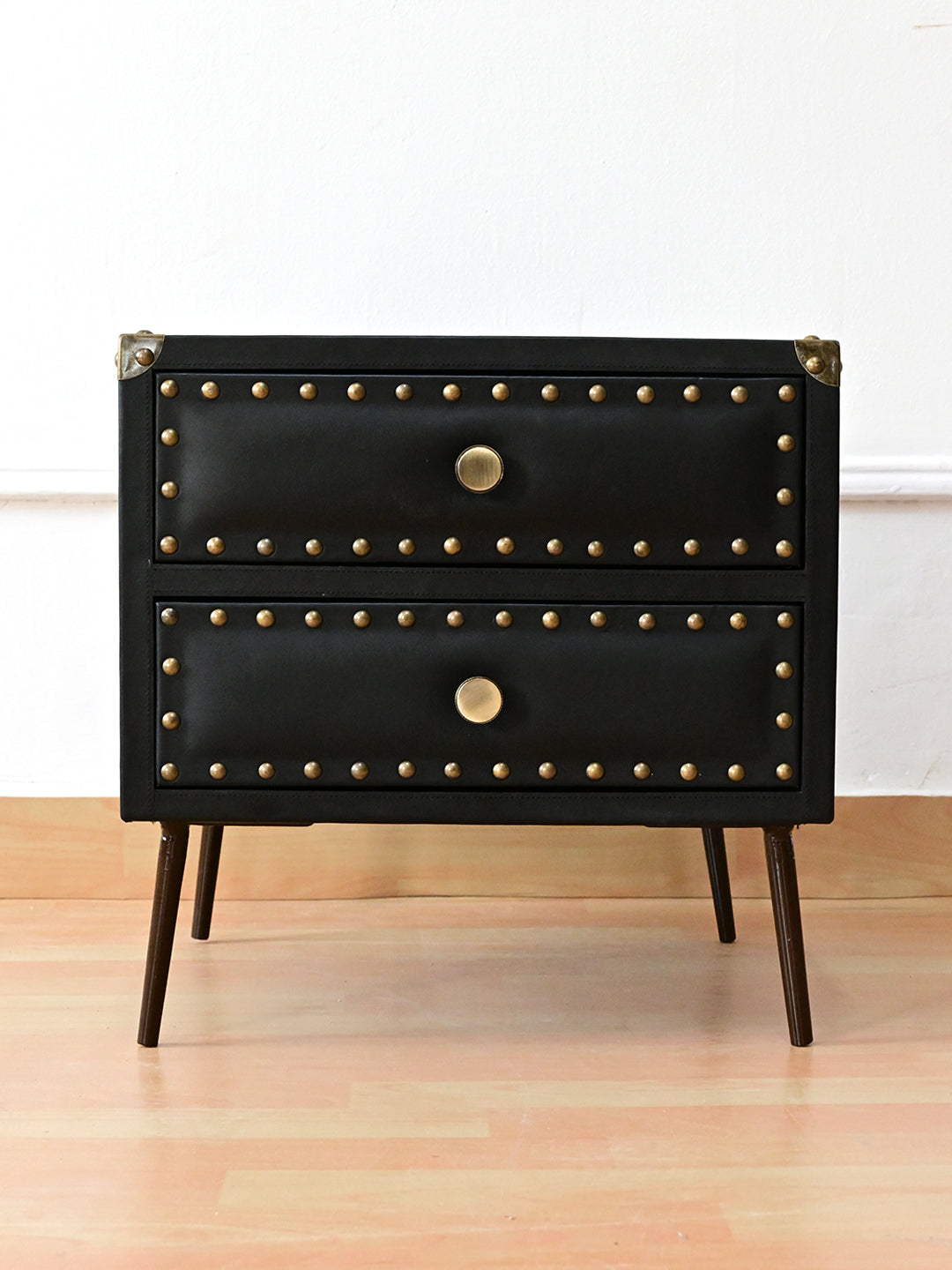 Kishangarh bedside table in Onyx leather, front view, two padded drawers framed in antique brass studs, Art Avenue