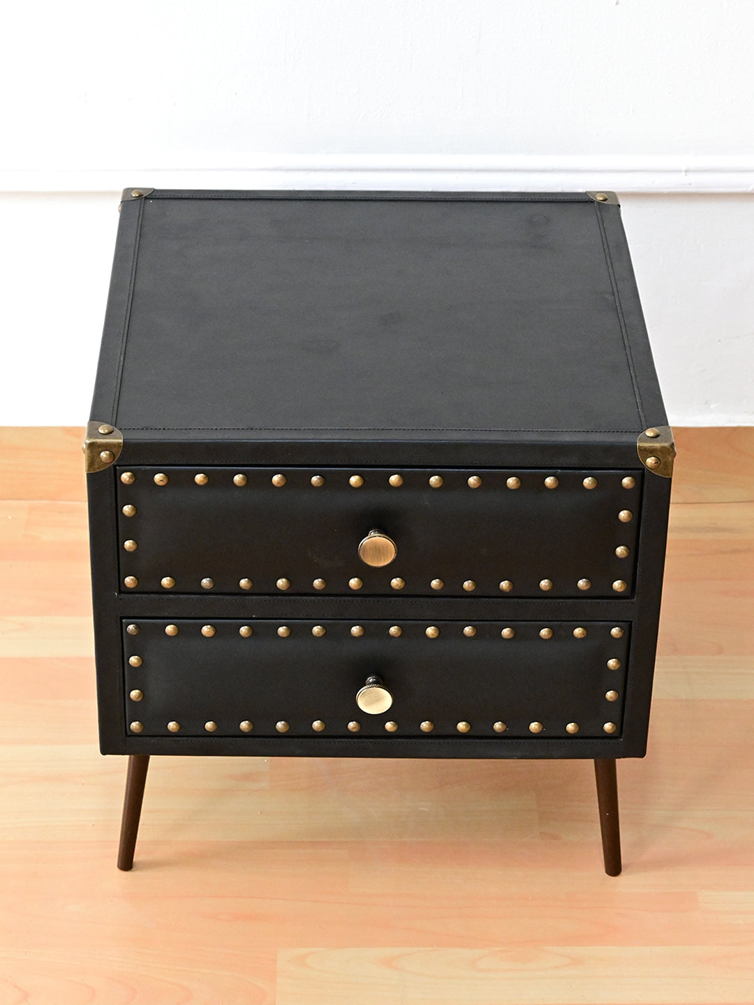 Kishangarh bedside table in Onyx leather from above, stitched inset top and cast brass corner caps, Art Avenue