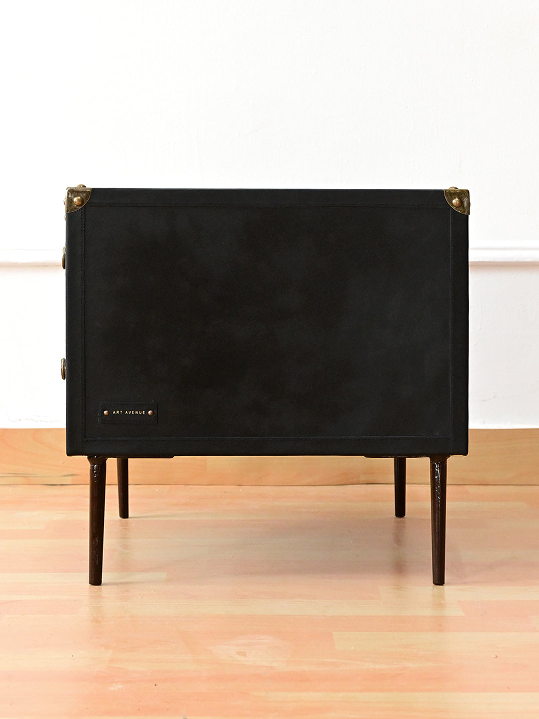 Side view of Kishangarh bedside table in Onyx leather, stitched flank panel and maker's tag, Art Avenue