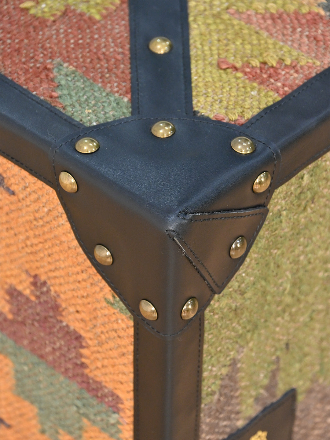 Macro of the leather corner protector and domed brass studs where the kilim panels meet, Mehrangarh coffee table, Art Avenue